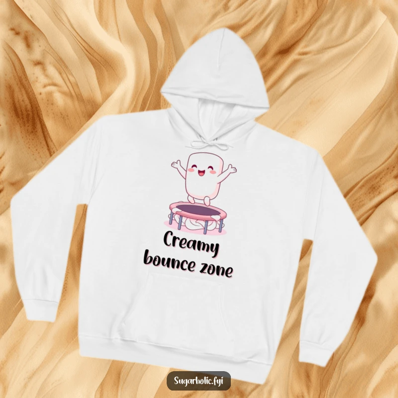 Funny hoodie showing an ecstatic marshmallow character bouncing gleefully on a whipped cream trampoline, perfect for cozy, fun-filled days.