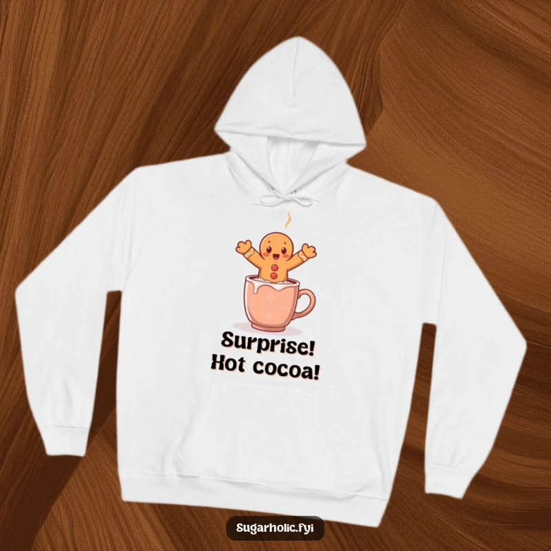 Funny hoodie showing a shocked gingerbread man comically jumping over a steaming mug of cocoa, capturing a moment of surprise.